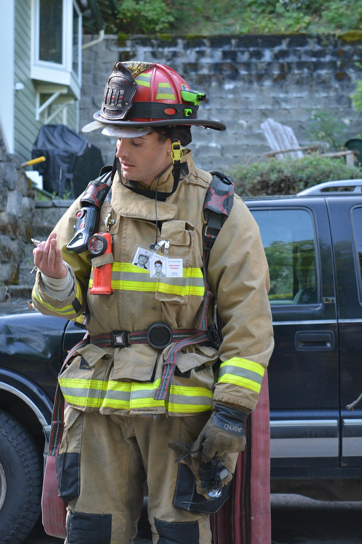 Victor Malsom of Shoshone Fire District One reads a snippet about the life of a fallen firefighter during the 9/11 memorial stair climb in Wallace.