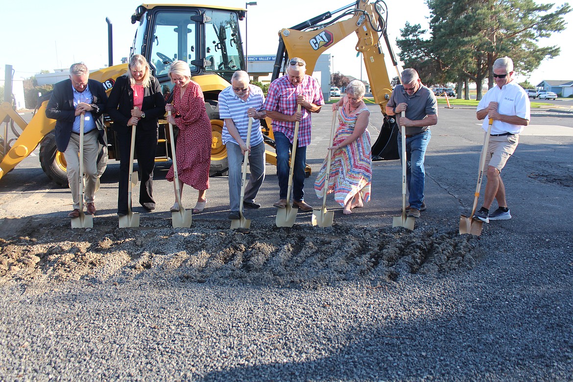 From left, Project Manager Joe Kunkel, Commissioner Michele Talley, CEO Glenda Bishop, Commissioners Robert Poindexter, Anthony Gonzalez, Sherri Kooy, Randy Zolman and Quincy City Administrator Pat Haley dig into the dirt at the groundbreaking ceremony for the new Quincy Valley Medical Center.