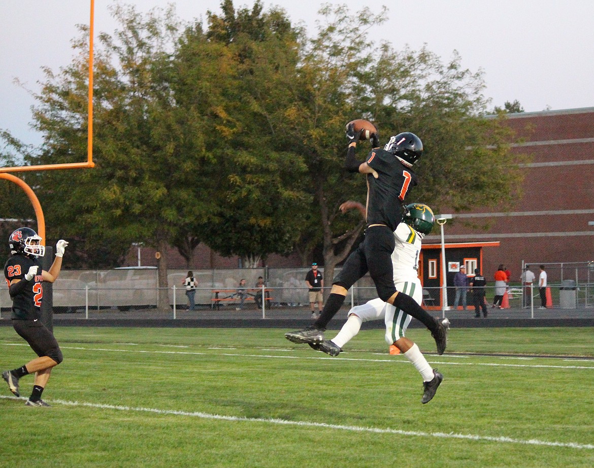 Ephrata receiver Hans Roberts (1) goes up for the touchdown against a Quincy defender in the Tigers’ 35-12 win over the Jacks Friday.