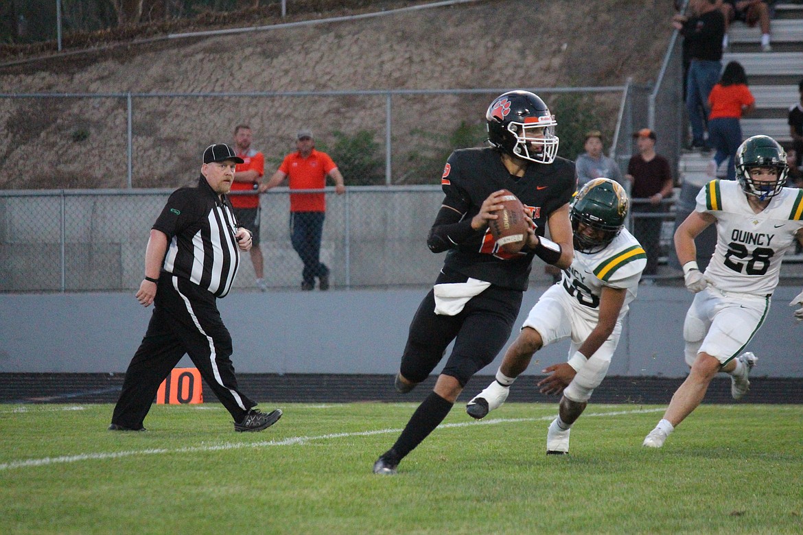 Ephrata quarterback Brady Hendrick rolls out to pass against Quincy.