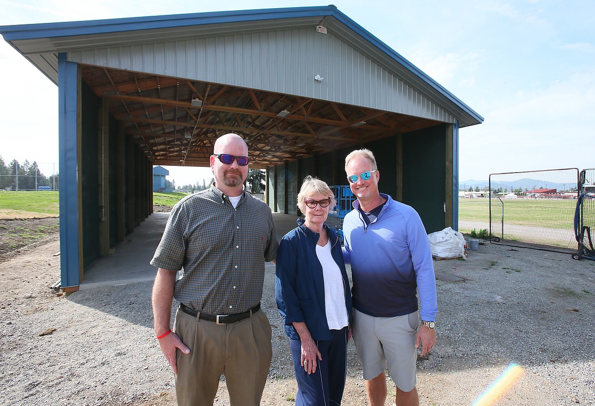 From left, Dan, Susan and John Schreiber pause for a photo Monday morning on the north side of the new Dave and Susan Schreiber Hitting Facility at Coeur d'Alene High School. John donated $200,000 to the baseball training building and named it for his mother and late father, who have contributed much of their time and talents to Coeur d'Alene High's academics and athletics through the years.