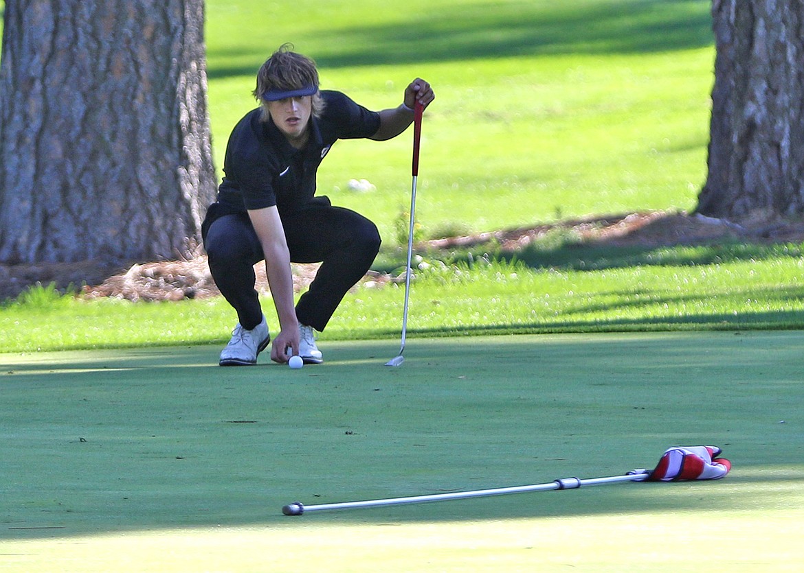 Pirate Torrin Ellis lines up the putt during Monday's Polson Invite. (Photo by Bob Gunderson)