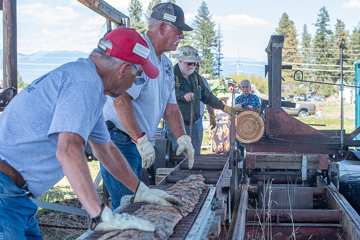 Howard Broscheit, Mickey Freese and Steve Skyberg demonstrate how an old saw mill works at Olsen Pioneer Park on Sept. 10.