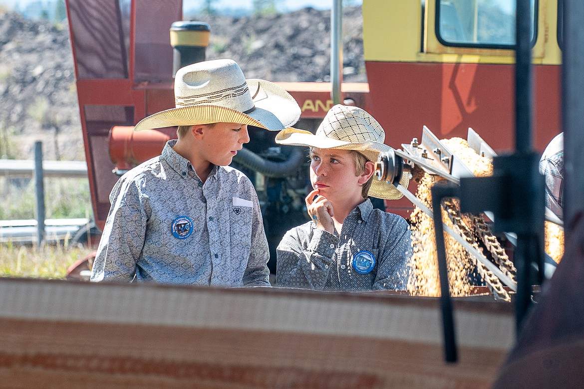 Corbin Wood and Brander Christianson discuss how the antique saw mill operates at the Northwest Antique Power Association’s Engine, Tractor and Threshing Bee at Olsen Pioneer Park on Sept. 10.