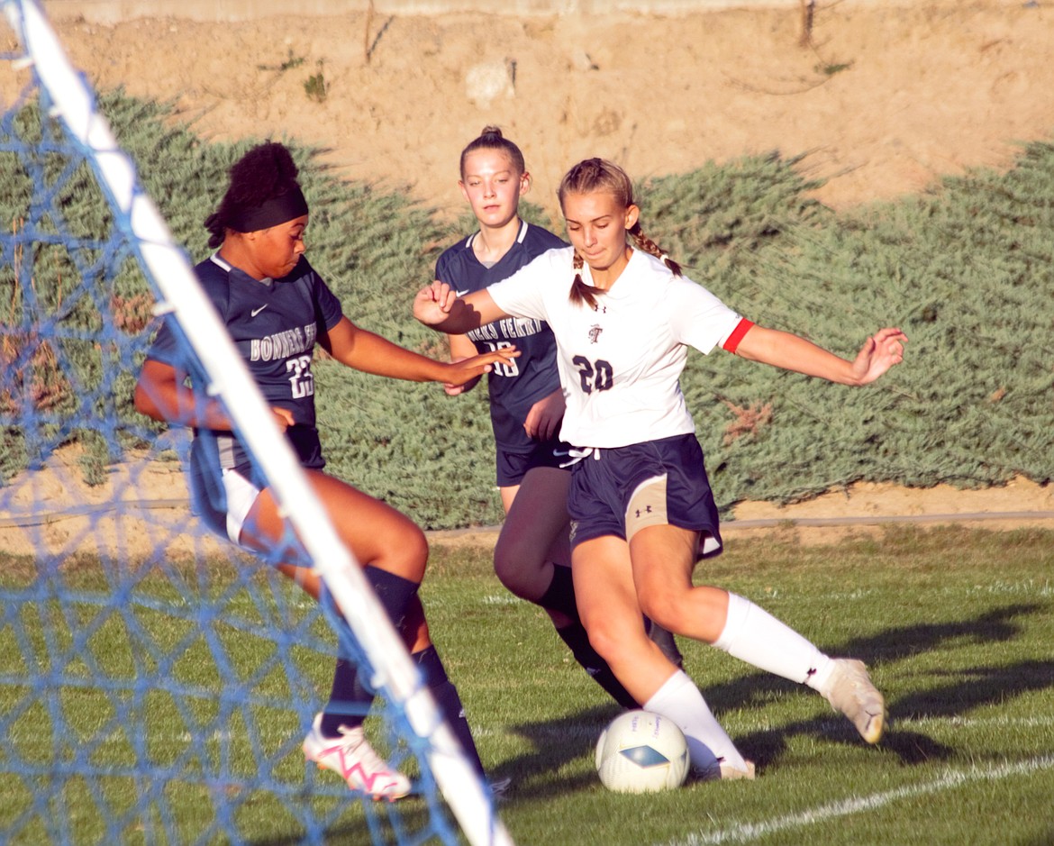 Asha Abubakari (left) plays defense for the Badges against Lucy Simpson #20 for Timberlake on Sept. 8.