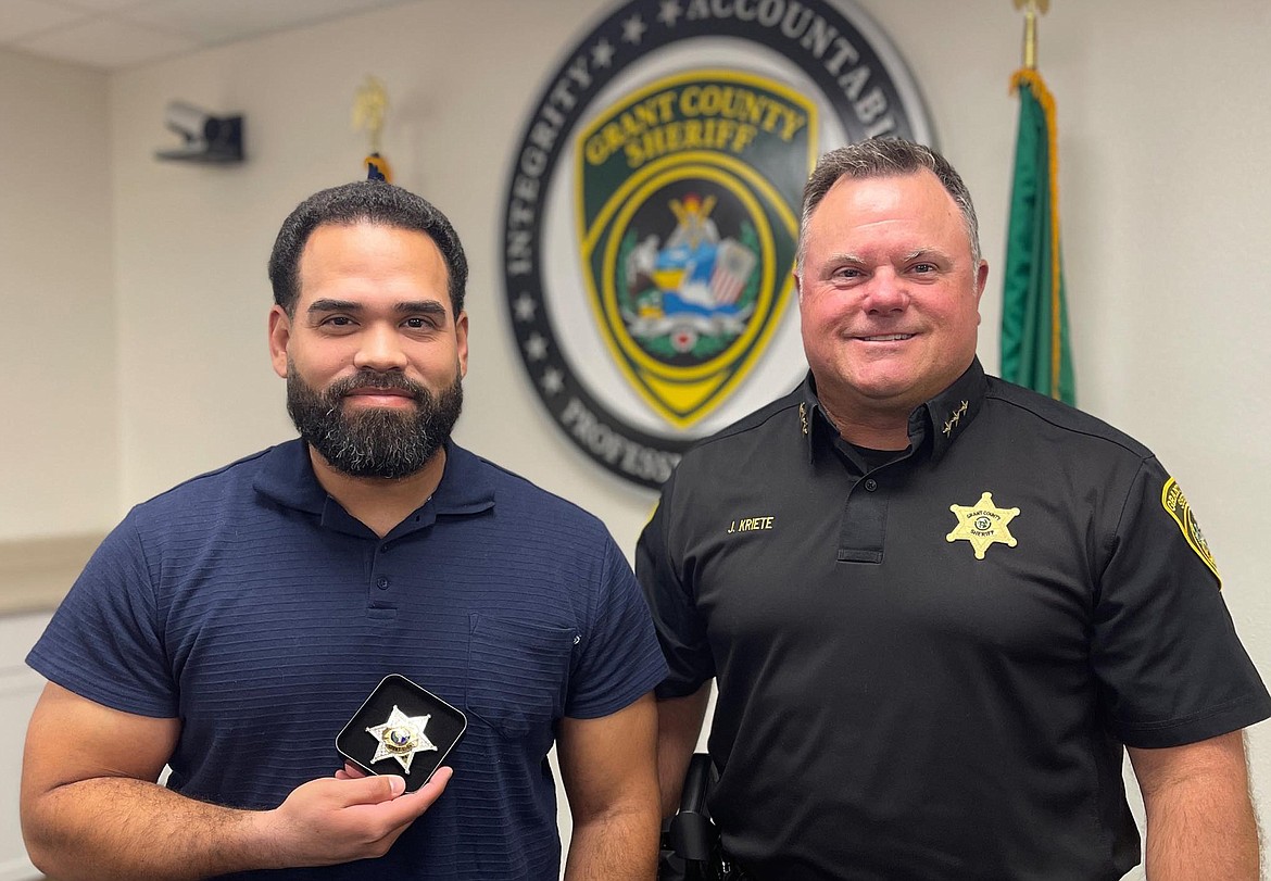 Corrections Deputy Jose Sorto, Jr., left, was sworn in by Grant County Sheriff Joe Kriete before an audience of Sorto’s new colleagues.