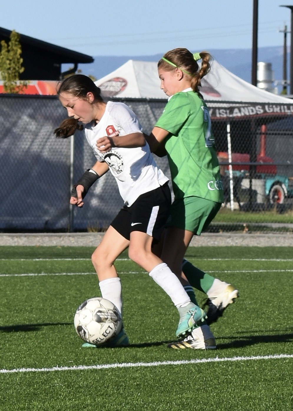 Photo by KARI HYNES
The Thorns North FC 11 Girls Academy soccer team continued its DPL league play last weekend in Post Falls with games against Seattle Celtic G11 DPL and Mt. Rainier FC G11 DPL. The weekend started with a 1-1 draw against the Seattle Celtics. Brightyn Gatten scored the Thorns' only goal with an assist from Mackenzie Dolan. During Sunday's game against Mt. Rainier FC G11 DPL Kylie Lorona scored an early goal with an assist from Presley Moreau (pictured above, at left). Presley scored next for the Thorns with an assist from Riley Greene. After playing the first half of the game as keeper, Mackenzie Dolan started the second half of the game with a quick goal at the start of the half and striker Presley Moreau scored a second goal to bring the final score to 4-0. The Thorns continue their DPL league games next week with a game against EW Surf.