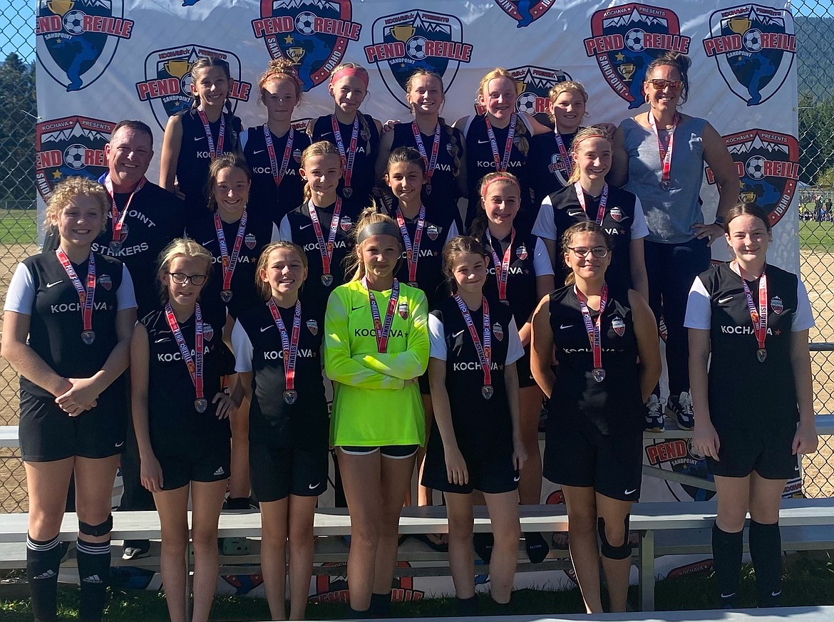 The Sandpoint Strikers FC U14/U15 girls team poses for a photo with their silver medals from the Pend Oreille Cup. Front row, left to right, Marley Pauls, Eleanor Whitesel, Sophia Sloan-Augustine, Breecyn Morton, Abigail VanGesen, Kailynn Doyle, and Lillian Gibeau. Middle row, left to right, Coach Jon VanGesen, Olivia Francis, Ruthie Laughridge, Meadow Shores, Ella Lett, and Willow Betz. Top row, left to right, Alyssa Porter, Maggie McClure, Raelyn Olsen, Avery Inge, Avah Archibald, Lillian Jackson, and Coach Kayla Ireland.