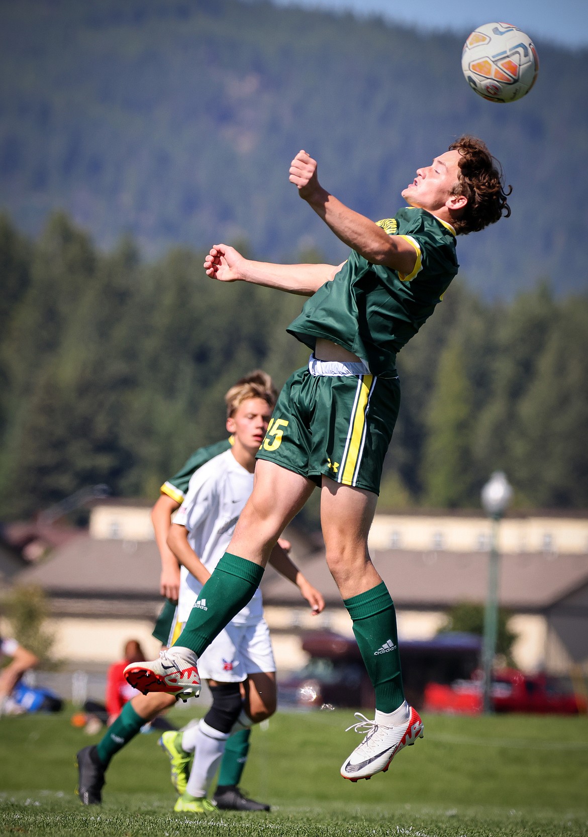 Whitefish midfielder Wyatt Carlson heads the ball during the Bulldogs' 4-0 over Bigfork Saturday. (Jeremy Weber/Bigfork Eagle)