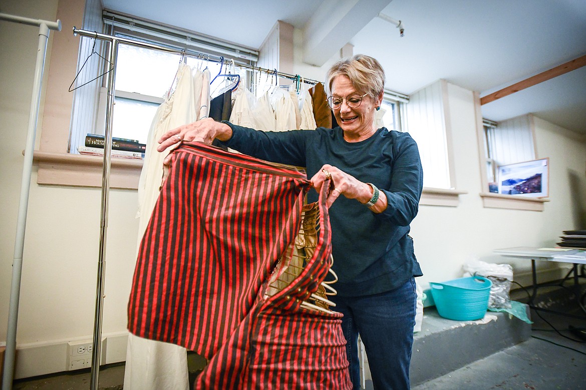 Terri Hill, a volunteer and the yard sale coordinator at the Northwest Montana History Museum, holds up the bustle frame from a 1800s-era dress that will be up for sale at the museum's yard sale. (Casey Kreider/Daily Inter Lake)