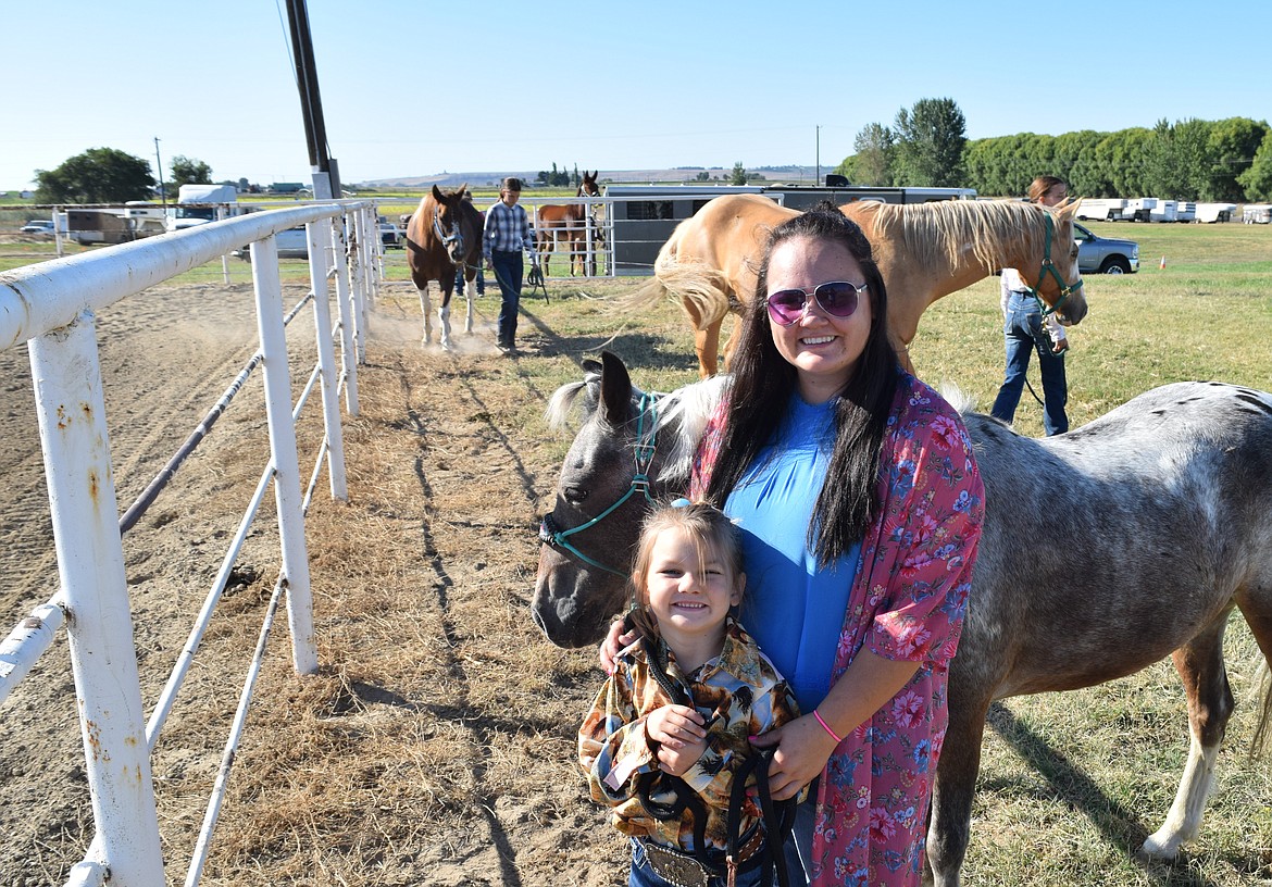 June Hamer and Katie Hammer stand in front of their pony, Iggy, before competing in the Halter and Showmanship competition, which was open to adults and younger children in addition to members of agricultural organizations.