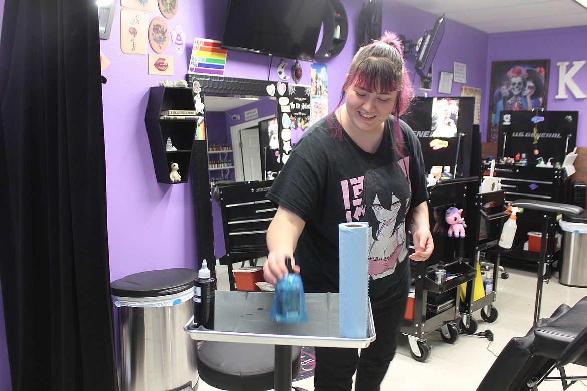 Blaire Knox sets up her workspace for a client. Knox is a tattoo artist at Karma Body Art in Moses Lake.