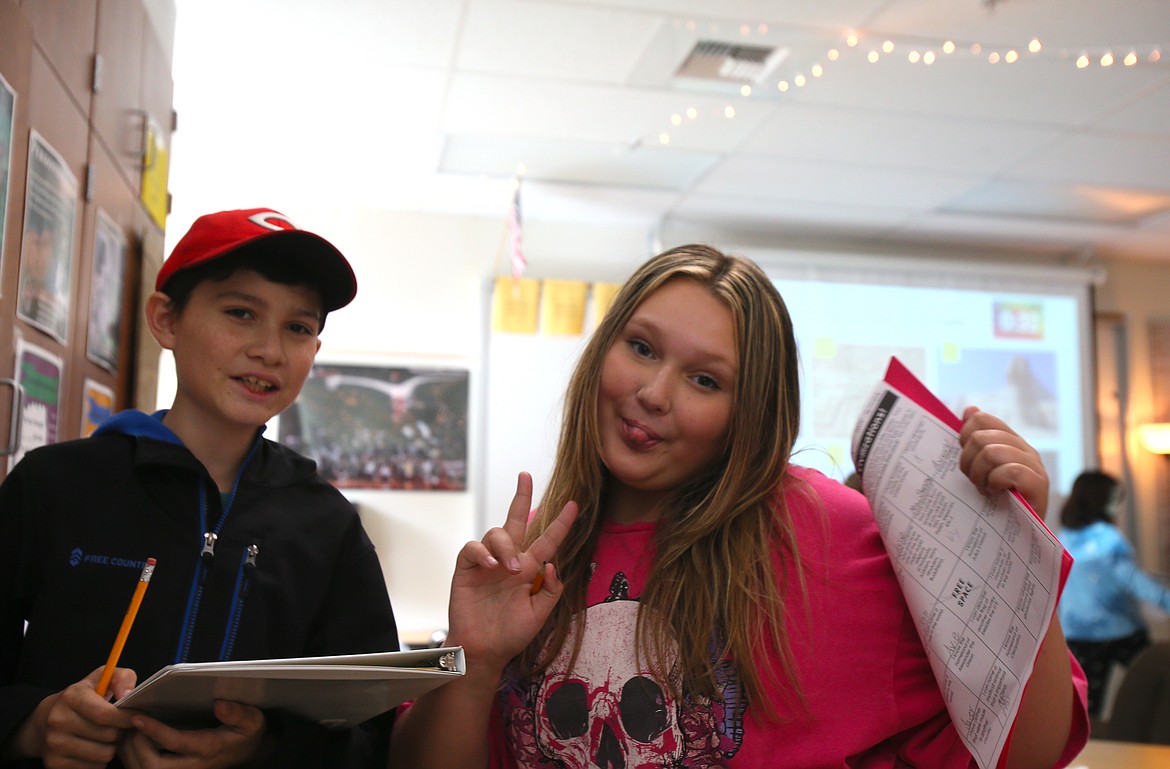 Jonathan Dawson and Starla Brinkley enjoy a geography exercise — and acknowledging the camera — Sept. 7 during their first week as sixth graders at Lakes Middle School.