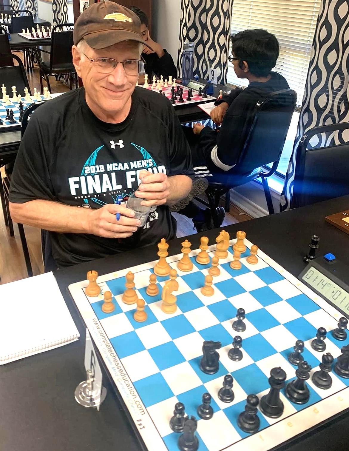 Steve Dahlstrom, organizer of the Coeur d'Alene Chess Club smiles during a game of chess.