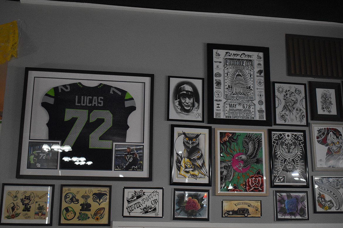 The jersey of Seattle Seahawks offensive tackle Abraham Lucas hangs on the wall at Obsidian Tattoo Collective in Moses Lake.