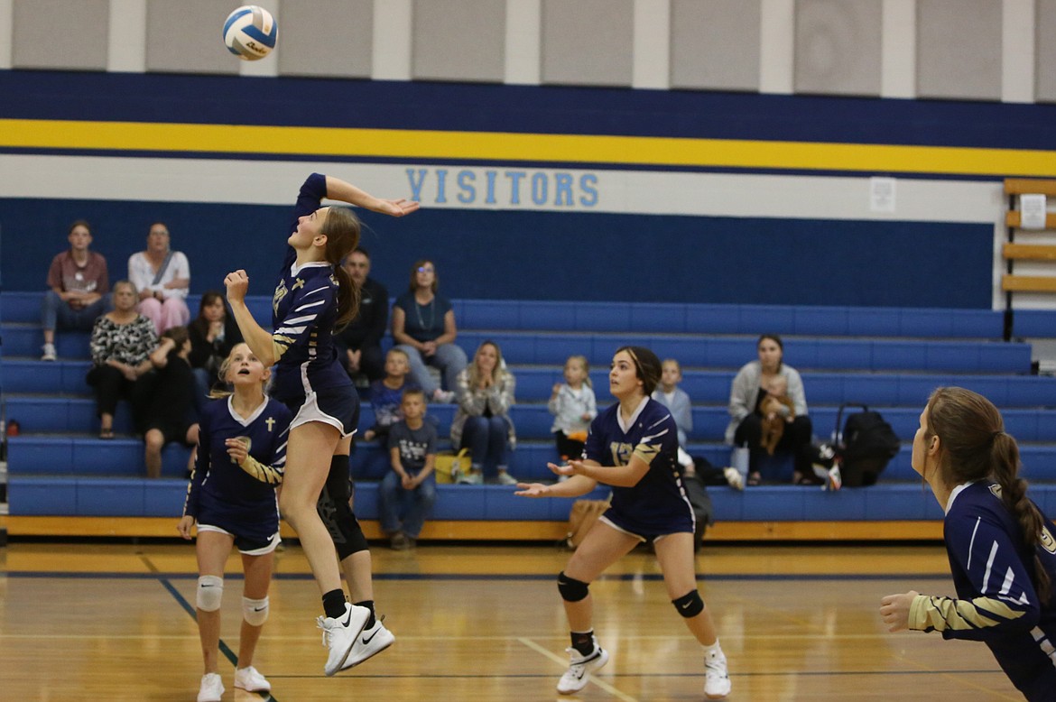 Moses Lake Christian Academy/Covenant Christian School senior Maria Gulenko, jumping, rises to hit the ball over the net against Wilson Creek on Tuesday.