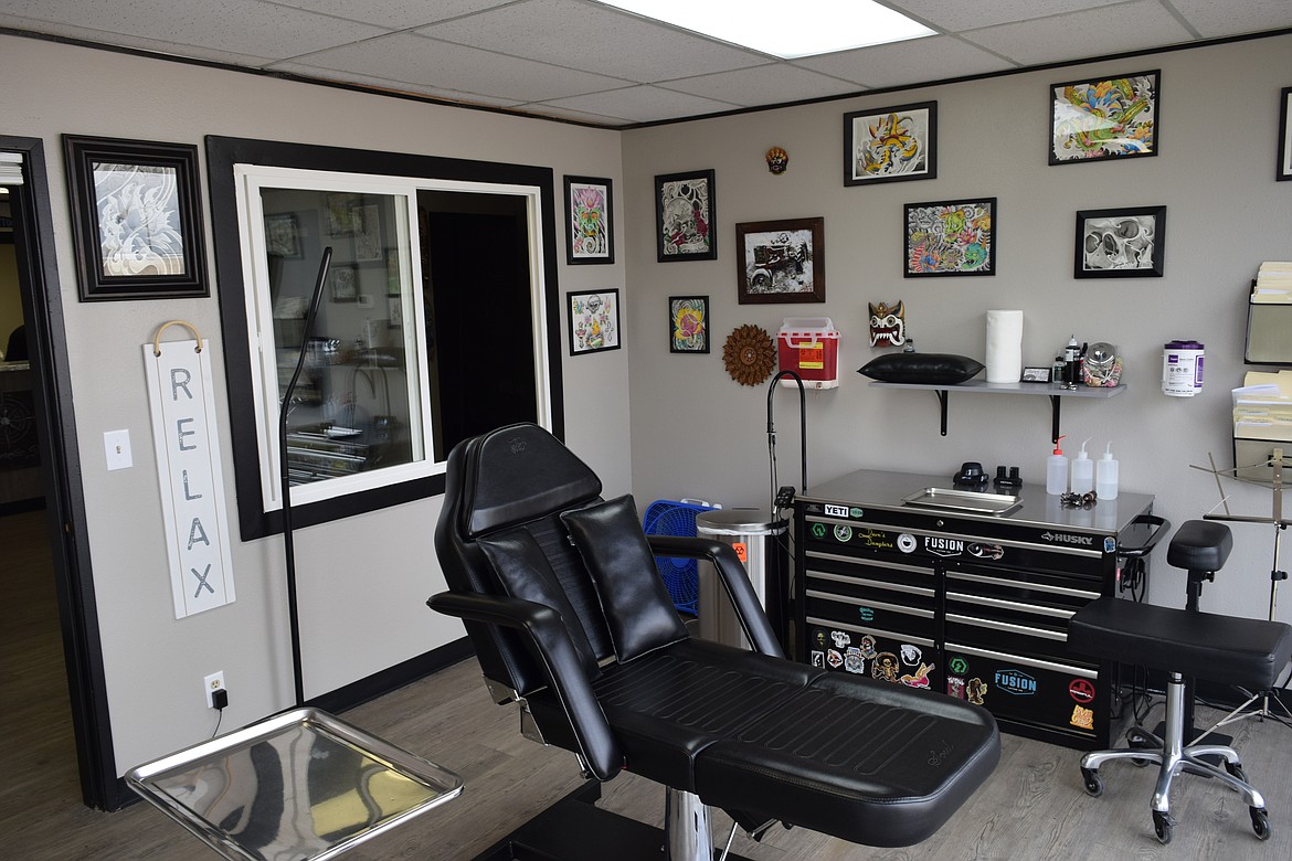 The seat where Eddie Bernier tattoos his clients at Magnetic Ink. Bernier’s own artwork lines the walls above the chair.