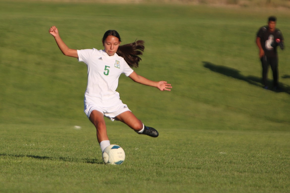 Quincy freshman Emiko Kondo passes the ball toward the Wahluke net in a 3-2 win over the Warriors on Sept. 7.