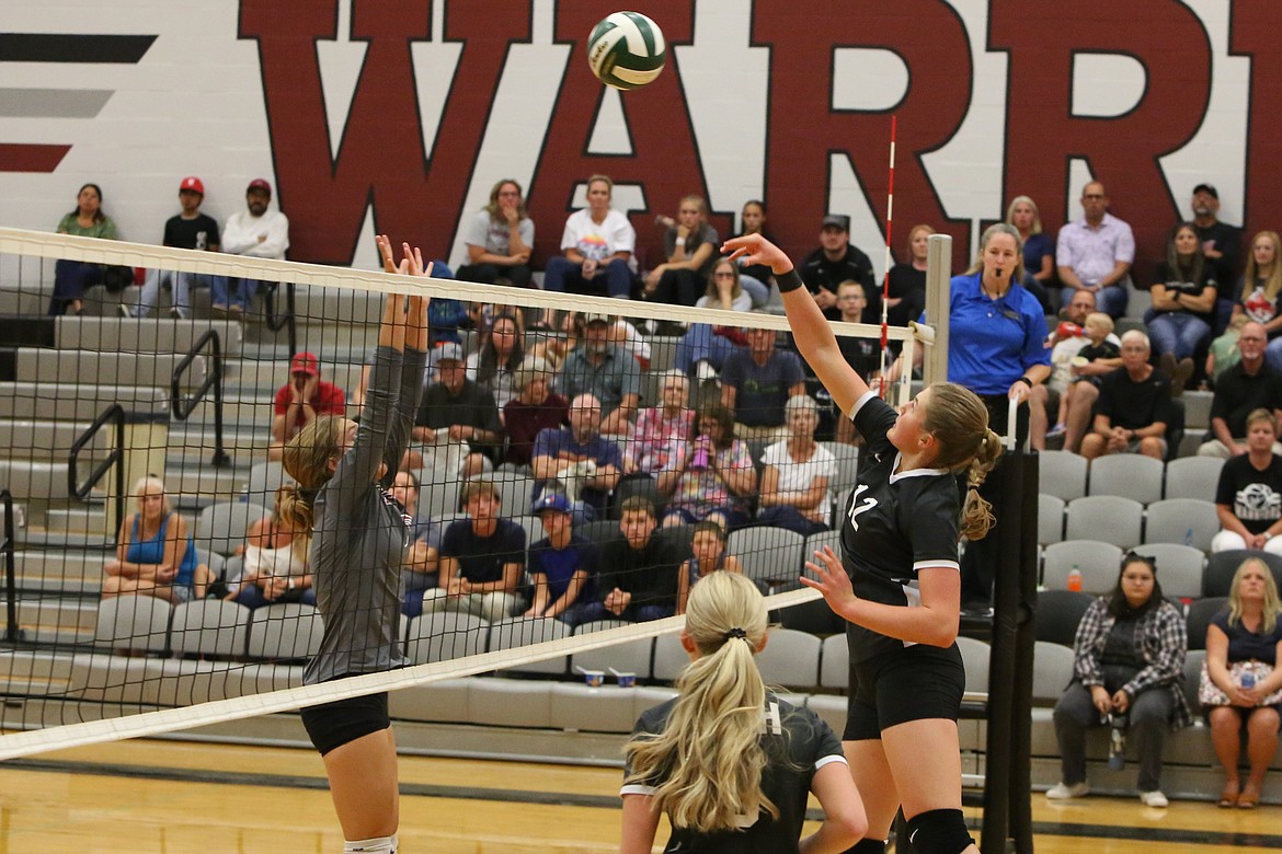 Almira/Coulee-Hartline senior Mariah McWalter (12) tips the ball over the net during the Warriors’ 3-0 win over Waterville-Mansfield.