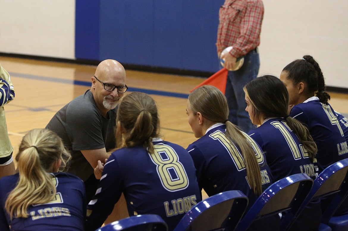 Moses Lake Christian Academy/Covenant Christian School Head Coach Dean Spurbeck, in grey, talks with players during a timeout in a game against Wilson Creek on Tuesday.