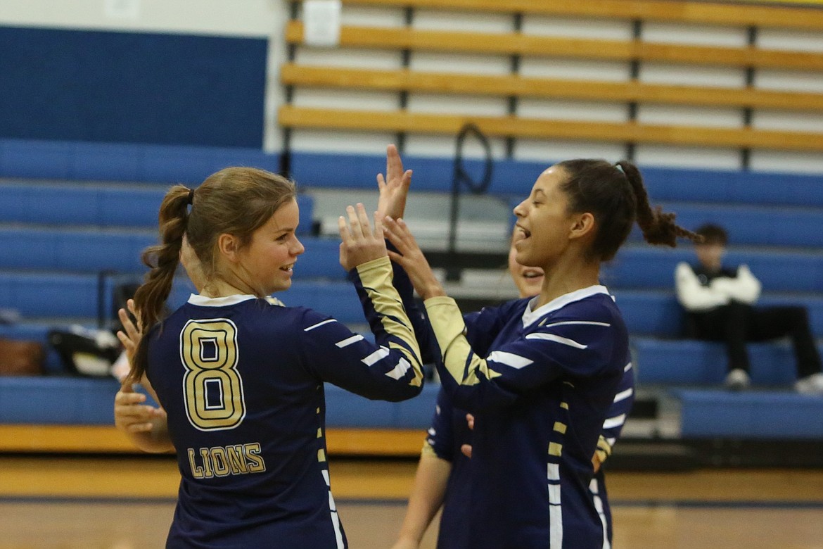 Moses Lake Christian Academy/Covenant Christian School players celebrate after a point in a game against Wilson Creek on Tuesday.