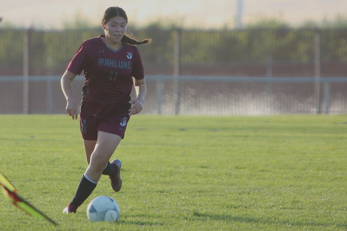 Wahluke junior Esmeralda Islas keeps her eye on the ball as she rushes upfield in the first half against Quincy.