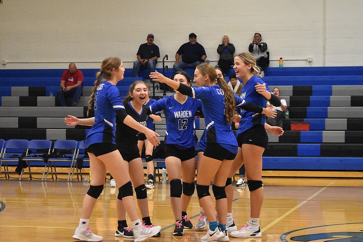 Warden players celebrate on the court during a match against Walla Walla Valley Academy in the 2022 season.