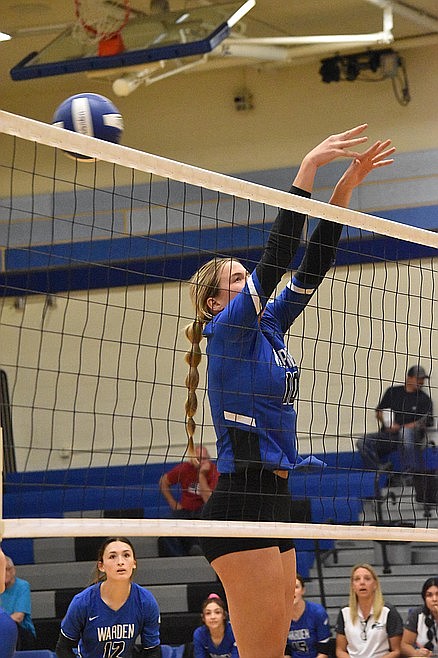 Warden senior Lauryn Madsen attempts a block.