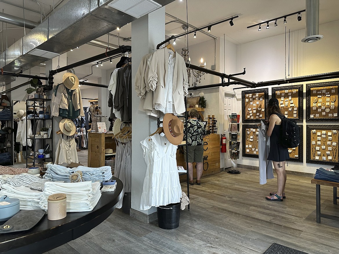 Shoppers wait to purchase items in a boutique on Tennyson Street Saturday, Aug. 5, 2023, in northwest Denver. On Thursday, the Commerce Department releases U.S. retail sales data for August.(AP Photo/David Zalubowski)