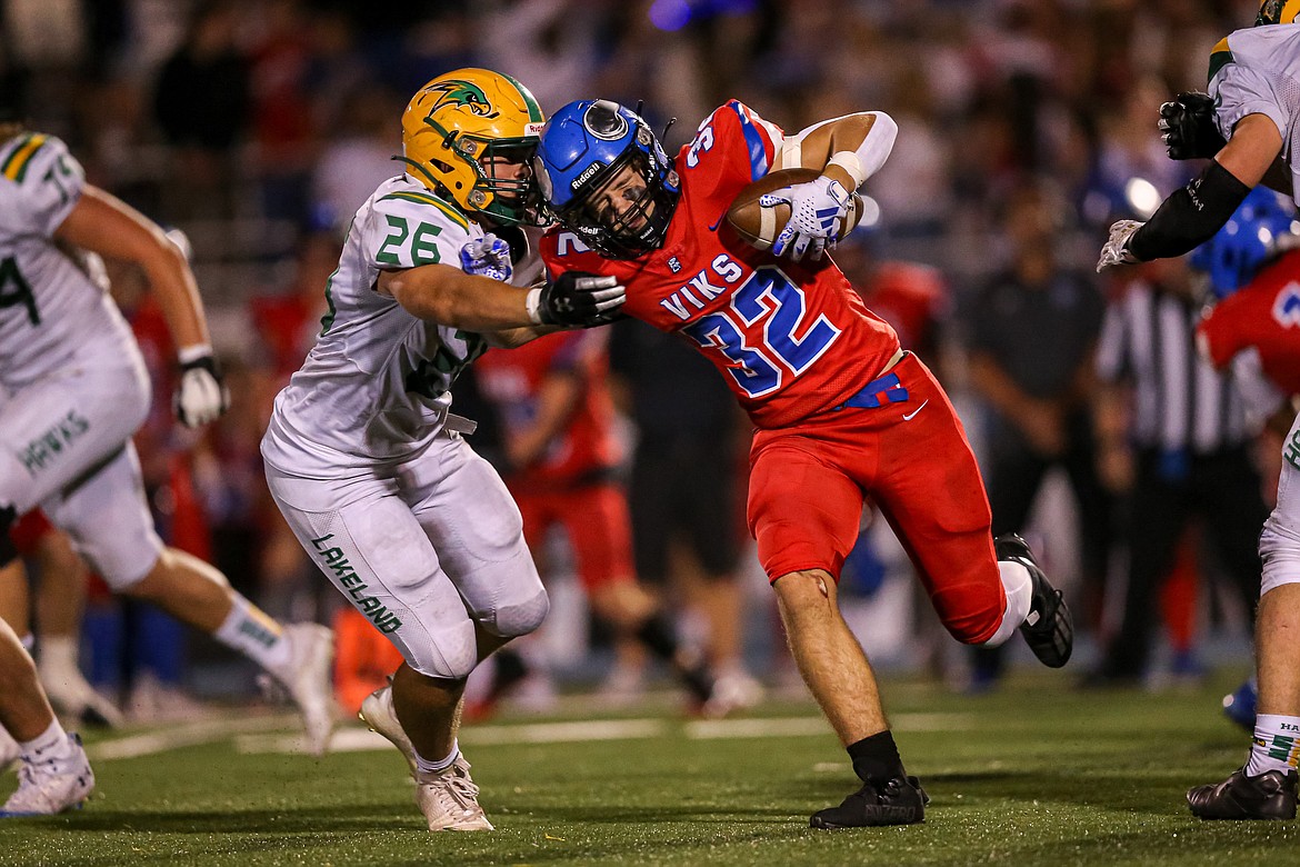 JASON DUCHOW PHOTOGRAPHY
Coeur d'Alene junior running back Brett Myers collides with Lakeland senior defensive back Reilly Saxe during the third quarter of Friday's game at Viking Field.