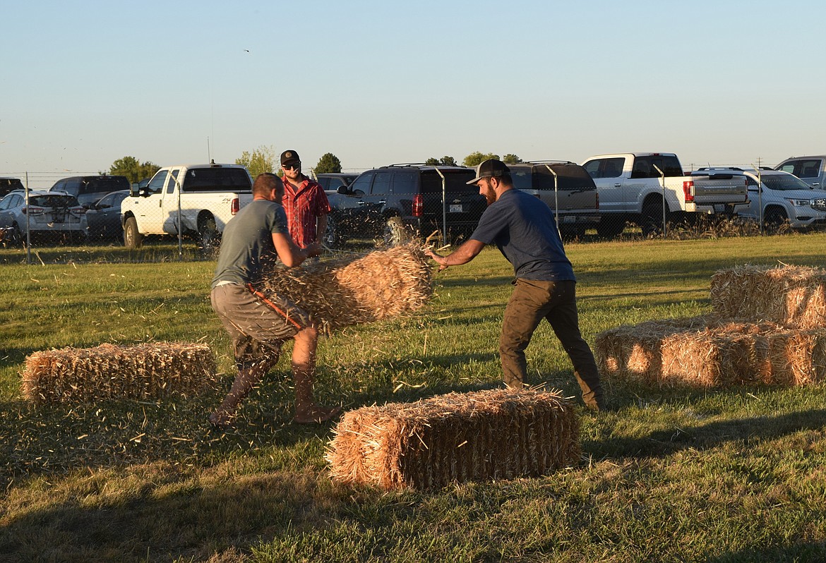 Eric Belnap, left, and Easton Roylance compete in the 2023 Hay Bucking Contest on the North Lawn of the Adams County Fairgrounds Thursday during the Othello Fair.