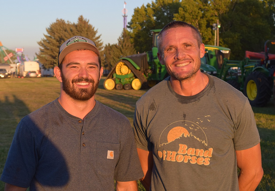 Easton Roylance, left, and Eric Belnap, right, the returning champions of the 2022 Hay Bucking Contest won again at the 2023 Othello Fair Thursday evening, netting them $1000 in prize money.