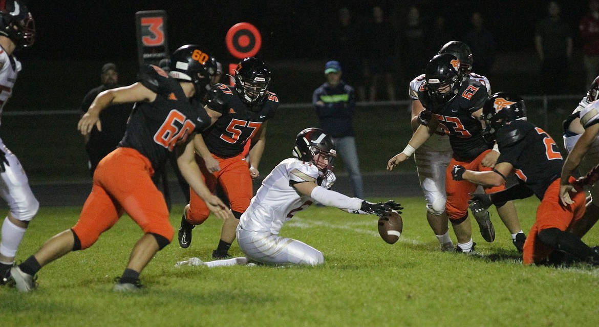 MARK NELKE/Press
Tanner Pulliam (60), Jaren Hansen (57), Martin Sebastean (63) and Crew Foreman of Post Falls surround Logan Troutman of University as he recovers his own fumble Friday night in Post Falls.