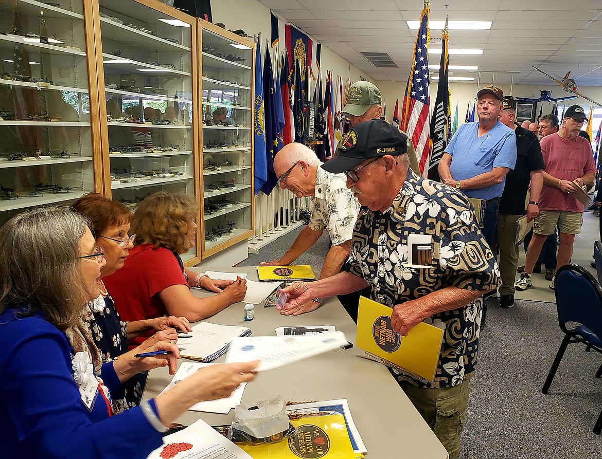 Daughter of the American Revolution member Shirley Stirling fills in a certificate with member LaVonne Whitaker, who thanks veteran James Beltramo for his service. The line of veterans extended around the room to receive a pin and to be welcomed home by the Daughters of the American Revolution and American Legion Post members.