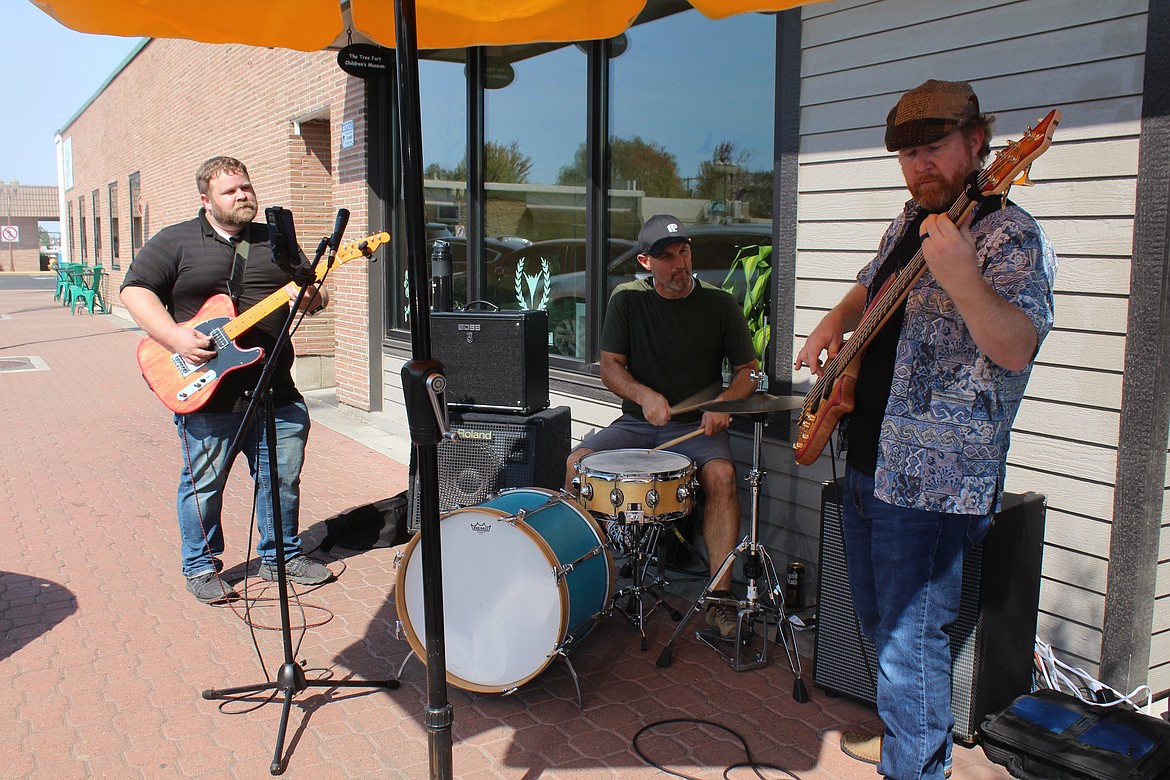 The Pangoleers, from left, Jack Tacher, John Owens and Michael Donaldson play a little rock ‘n roll during Sip ‘n Stroll, sponsored by the Downtown Moses Lake Association.