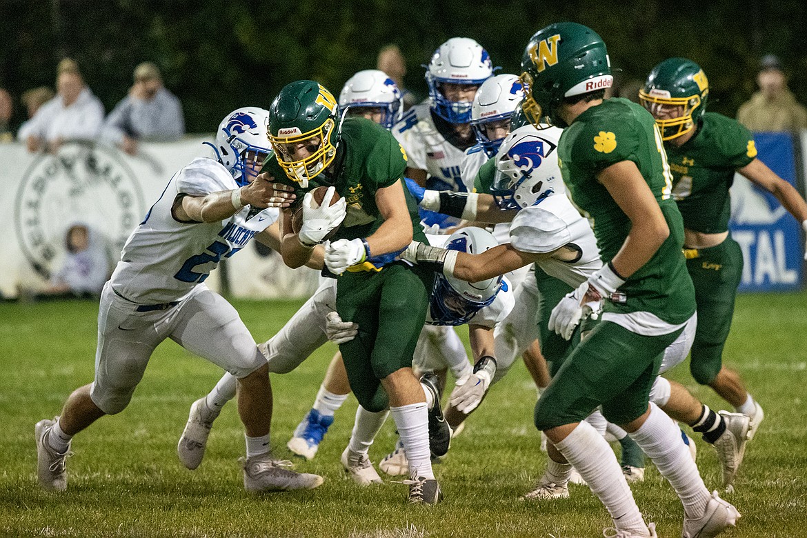 Whitefish's Dane Hunt (4) runs the ball at the Dog Pound on Friday, Sept. 15 in a game against Columbia Falls. The Bulldogs won in overtime, 20-14. (Avery Howe/Hungry Horse News)