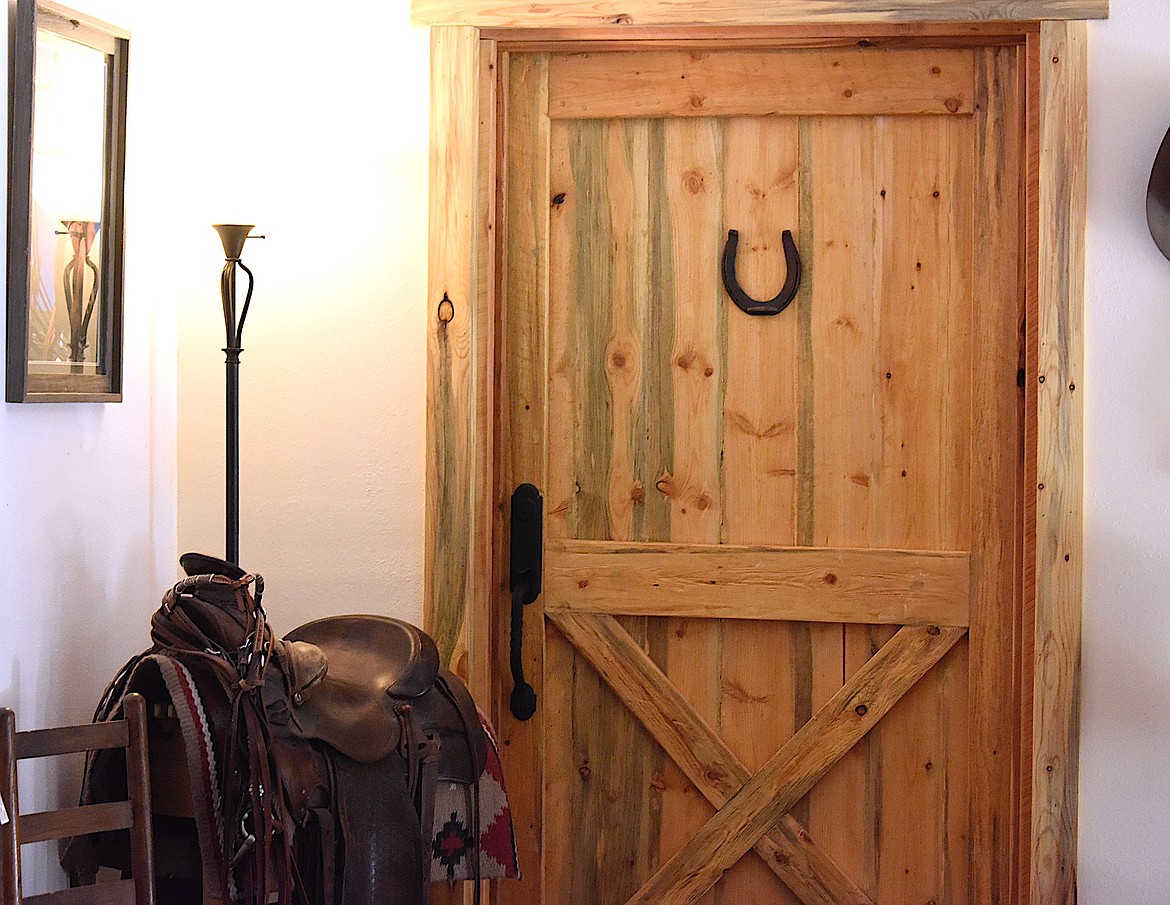 Jodie L. Hooker's dad's saddles and cowboy gear decorate the Ronan Bunkhouse. (Berl Tiskus/Leader)