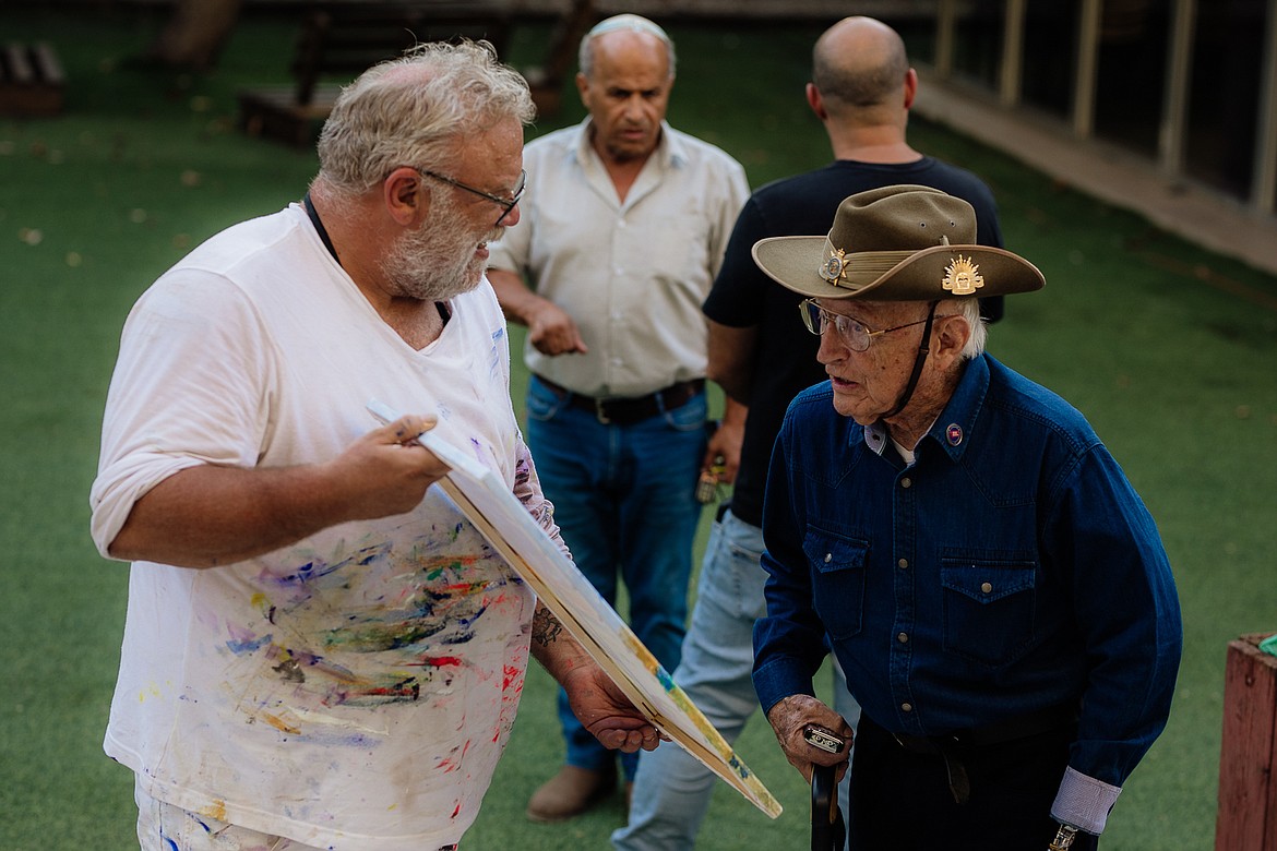 David Williams presents his art to decorated Israeli veteran Obed Negbi at the Givati Brigade base in Israel. (Abigail Maki photo)