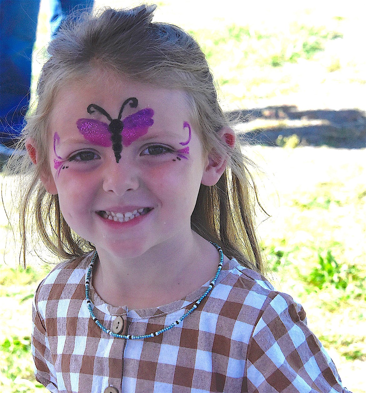 Aria Luchau, 5, had her face painted at the Ronan Harvest Fest. (Berl Tiskus/Leader)