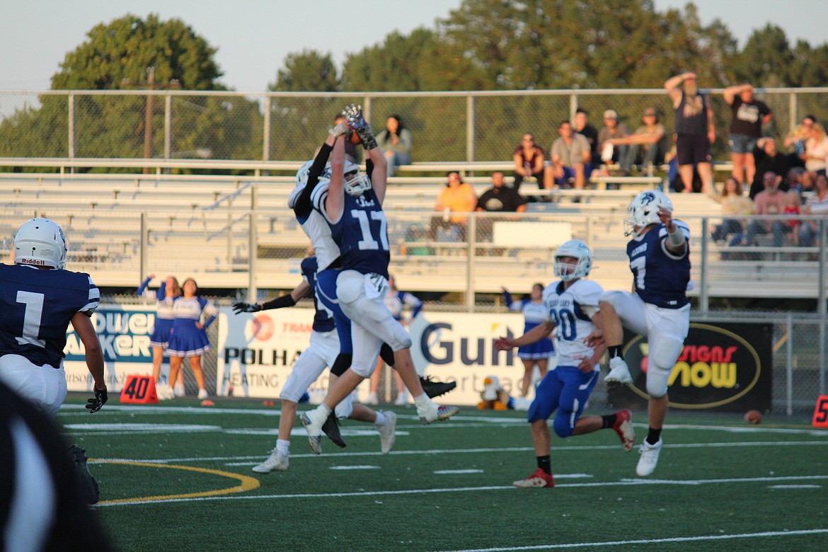 Lions receiver James Robertson (17) battles an Eagle defender for the ball.