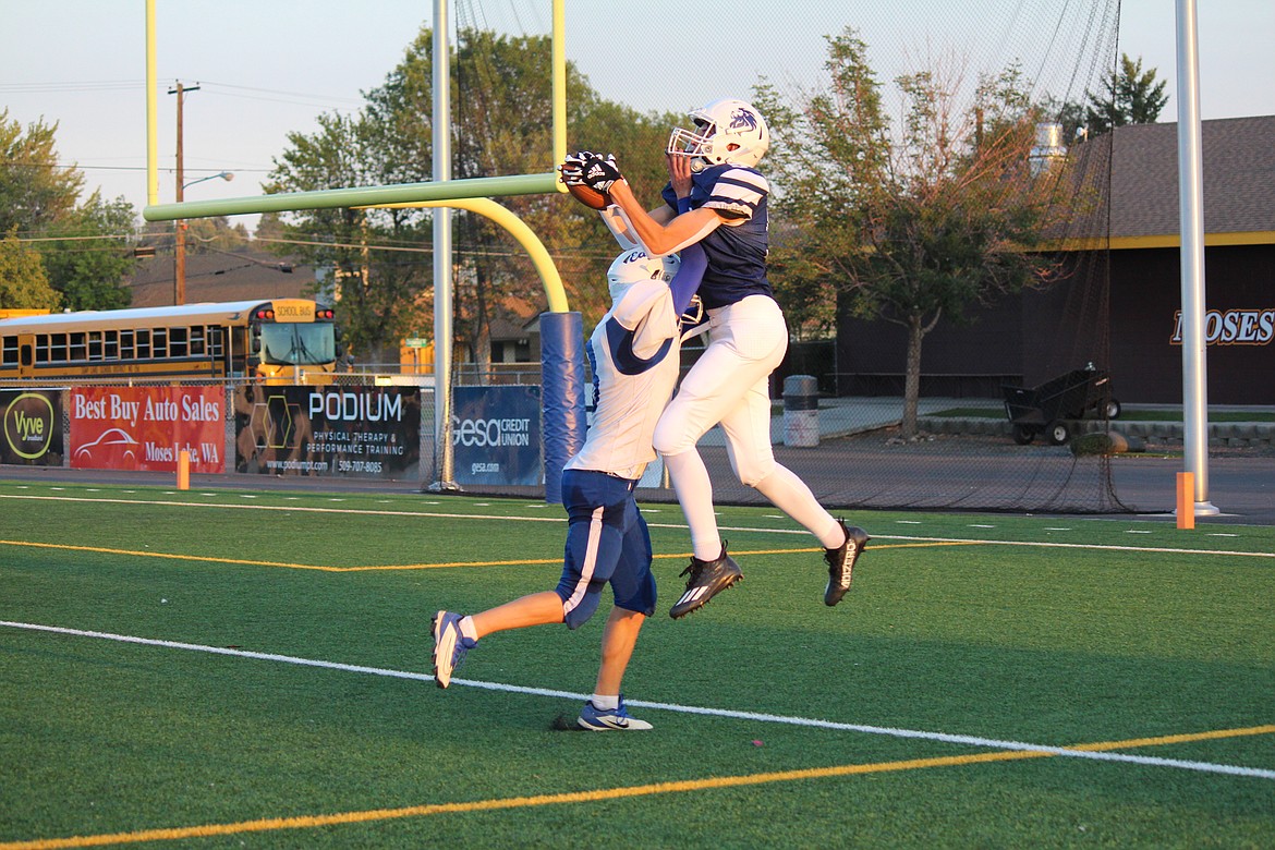 MLCA/CCS receiver Jonny Ferguson (5) hauls in a touchdown pass over a Soap Lake defender in the Lions’ 44-30 win Saturday.