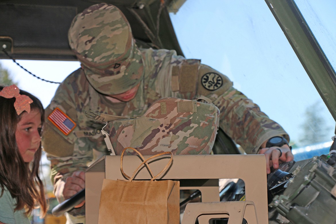 A youngster gets buckled into an armored vehicle at the recent Ponderay Neighbor Day event. Hundreds of people turned out for the annual celebration of community on Sept. 9.