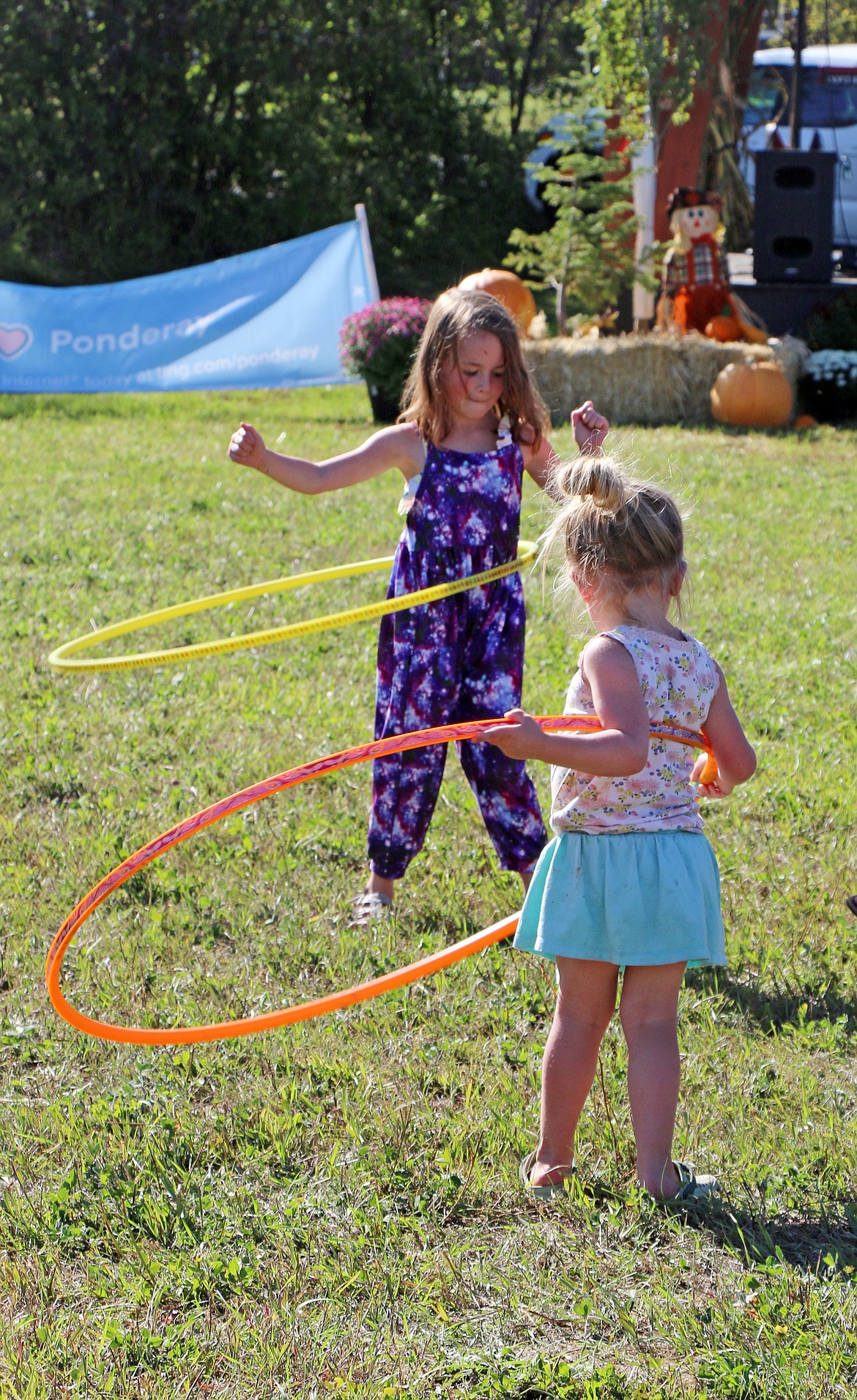 A pair of youngsters spent some time hula-hooping to the music during the recent Ponderay Neighbor Day event.