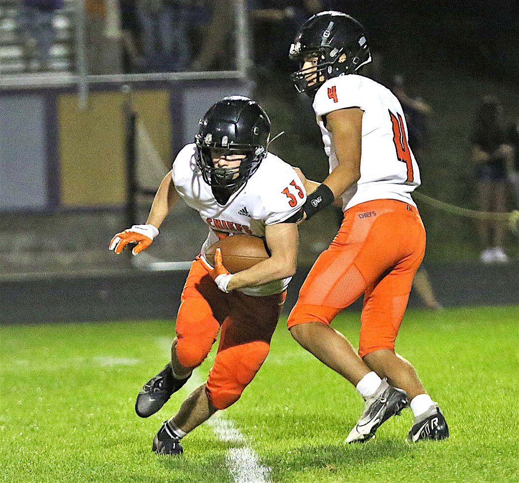 Ronan running back Wiljames Courville takes a handoff from quarterback Kolby Finley during Friday's game against Polson. (Bob Gunderson photo)