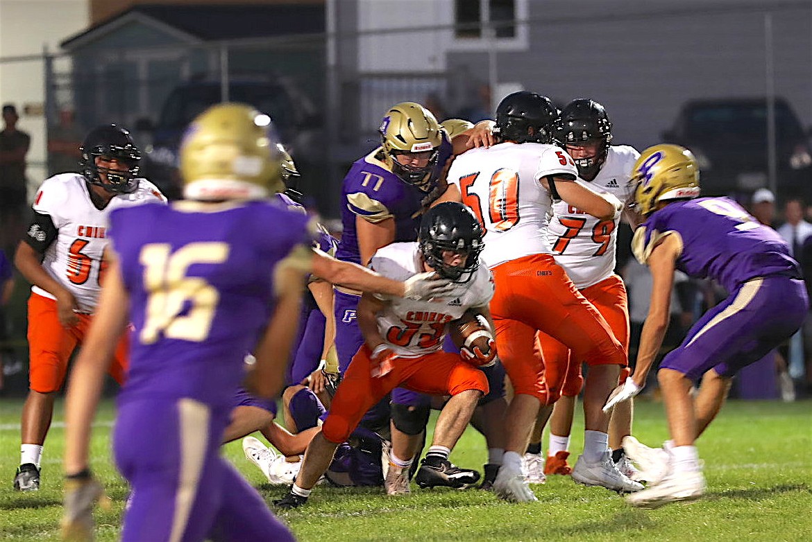 Ronan Chief Wiljames Courville works his way through the Pirate defense behind Mason Wayman and Jackson Davis during last Friday's game in Polson. (Susan Lake photo)