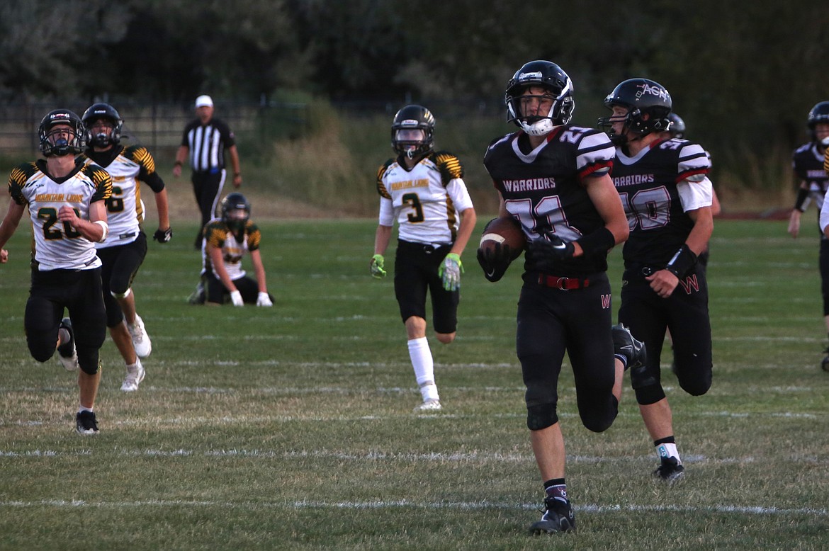 ACH sophomore Brady Roberts runs past the Liberty Bell kickoff coverage on an 85-yard kickoff return touchdown against the Mountain Lions on Saturday.