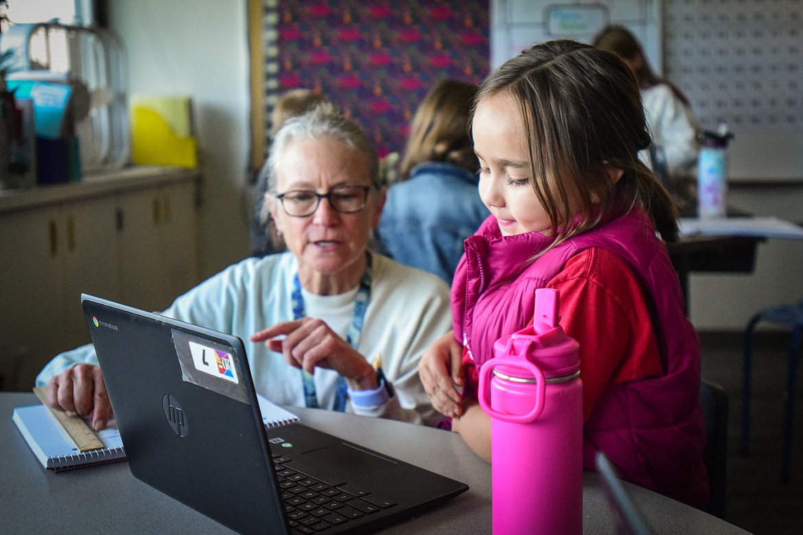 Second-grade teacher Sharon Sinclair helps a student use SeeSaw, a website that helps kids generate a word cloud about themselves, in her classroom at Edgerton Elementary School on Tuesday, Sept. 19. (Casey Kreider/Daily Inter Lake)