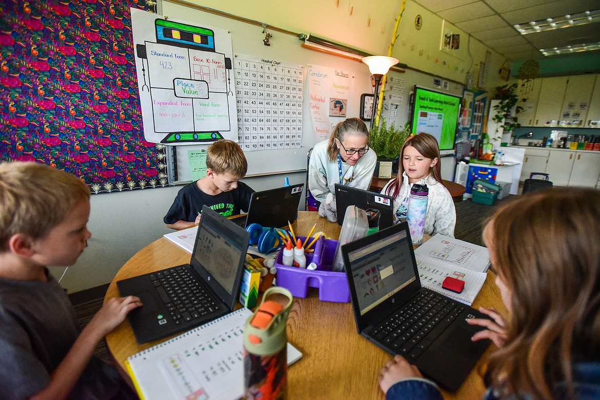 Second-grade teacher Sharon Sinclair helps her class use SeeSaw, a website that helps students generate a word cloud about themselves, at Edgerton Elementary School on Tuesday, Sept. 19. (Casey Kreider/Daily Inter Lake)