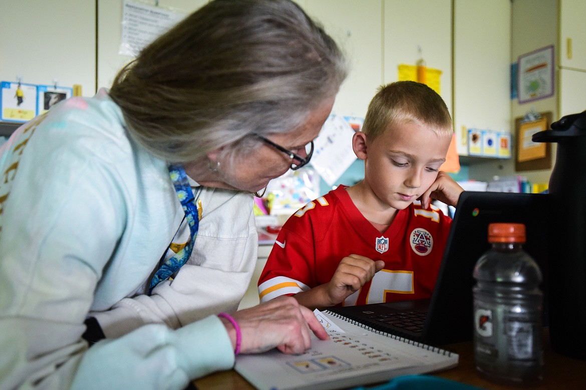 Second-grade teacher Sharon Sinclair helps a student use SeeSaw, a website that helps kids generate a word cloud about themselves, in her classroom at Edgerton Elementary School on Tuesday, Sept. 19. (Casey Kreider/Daily Inter Lake)