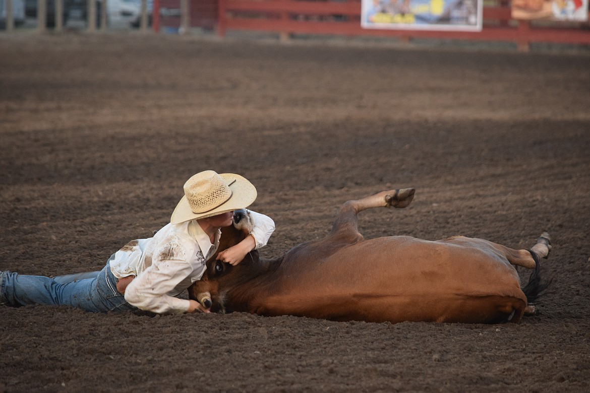 Caleb McMillan wrestles a steer to the ground at the Ritzville Labor Day Rodeo on Sept. 2.